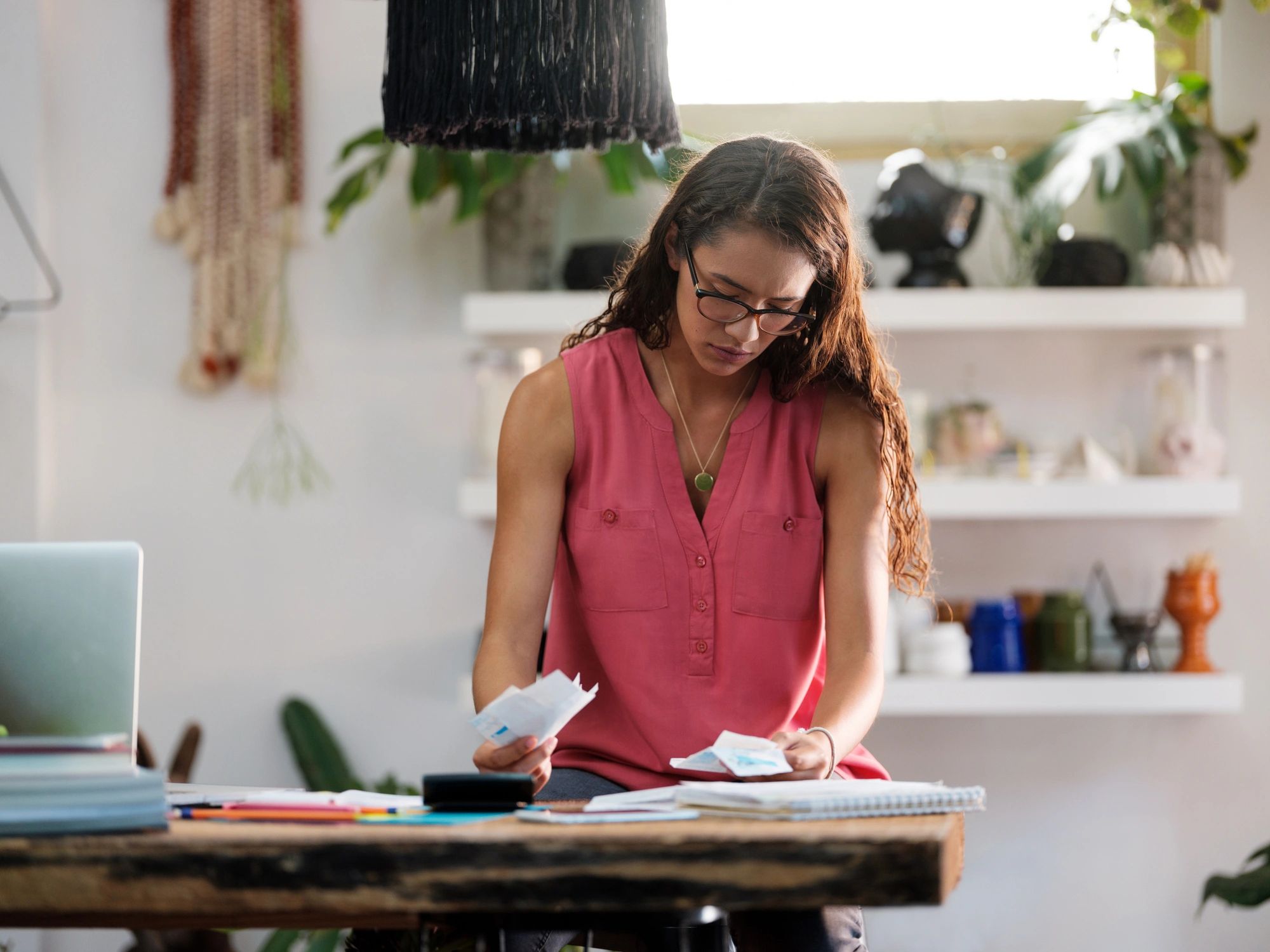 Person reviewing paperwork at a desk
