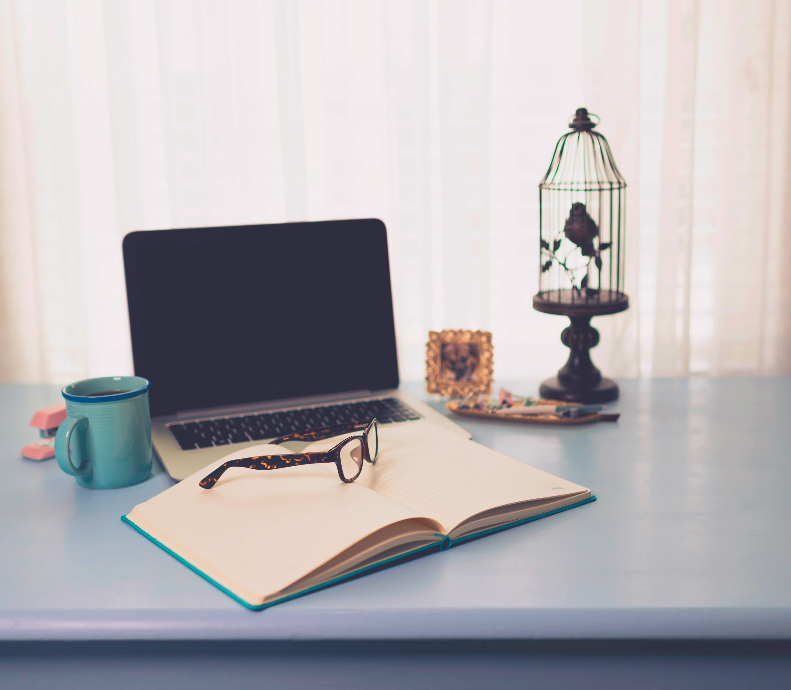 Writing desk with laptop and lined notebook. Working from home. Home office
