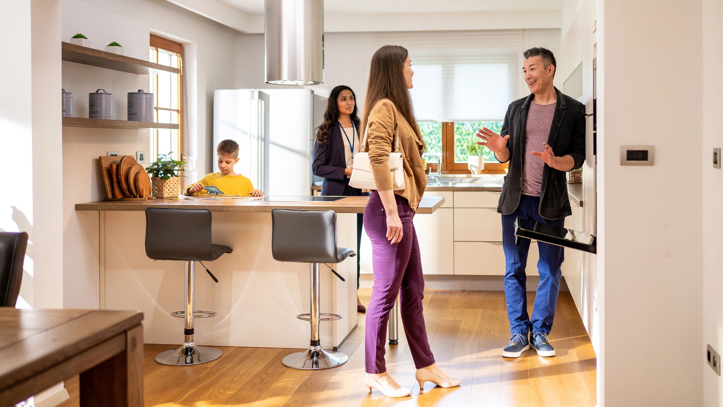 Couple viewing a home kitchen during a showing