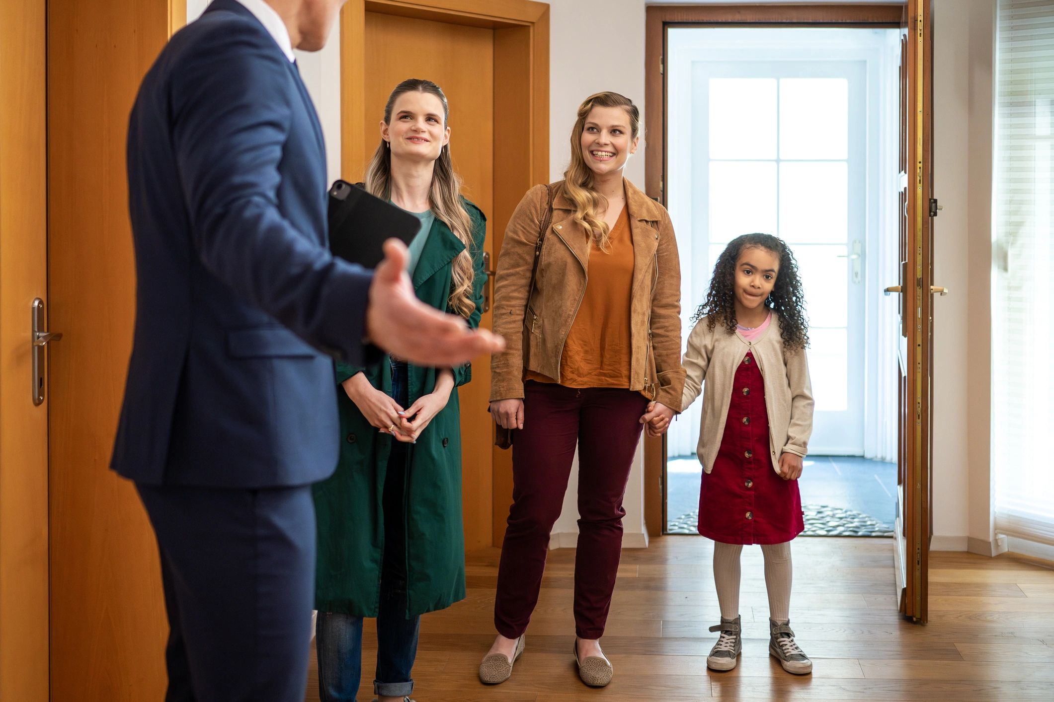 Family touring a home with a real estate agent