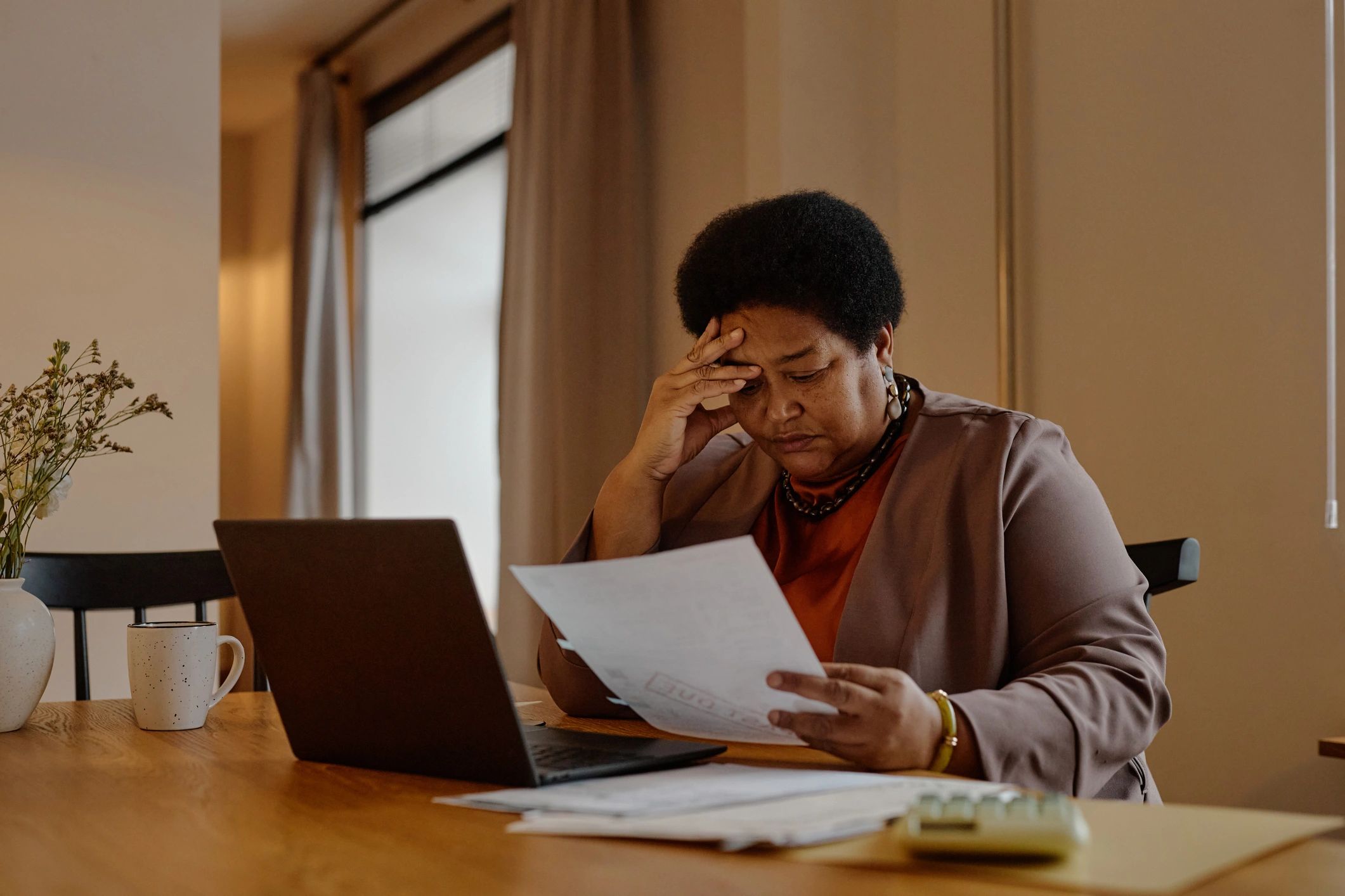 Homeowner reviewing insurance and financial documents at a desk