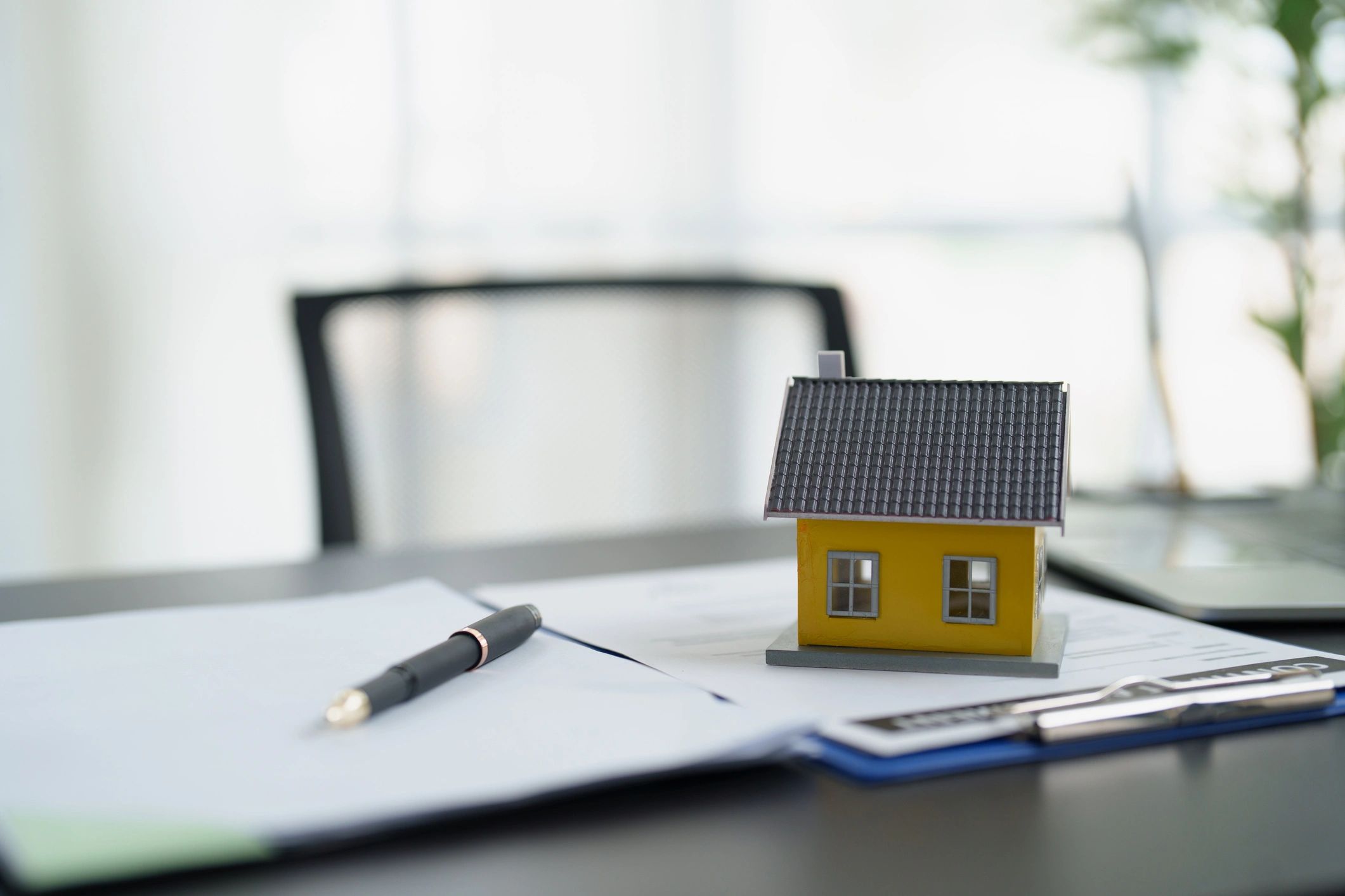 Model house on homeownership documents